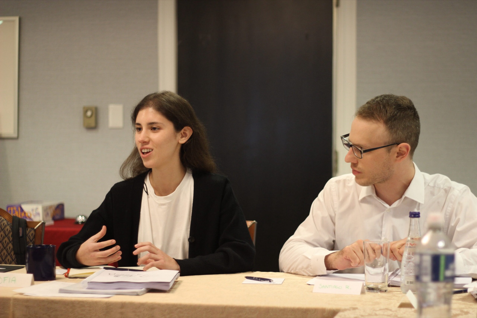 A seminar discussion in progress around a conference-room table.
